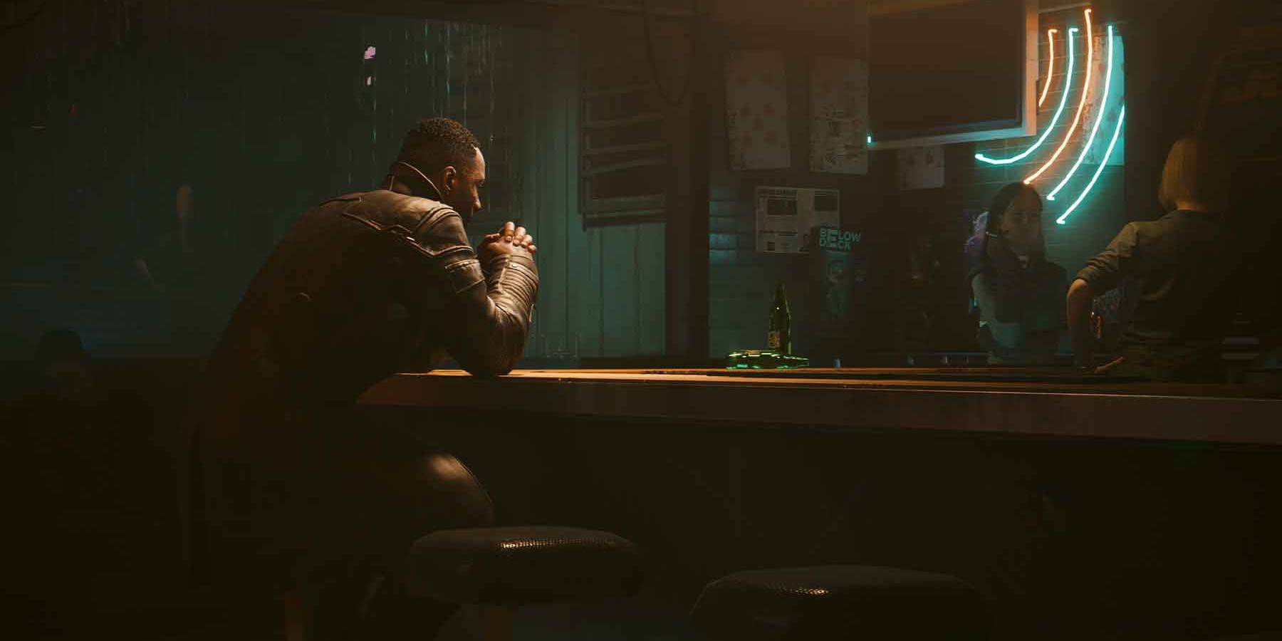 A screenshot of Idris Elba's Solomon Reed sitting in a darkned bar in Cyberpunk 2077: Phantom Liberty.