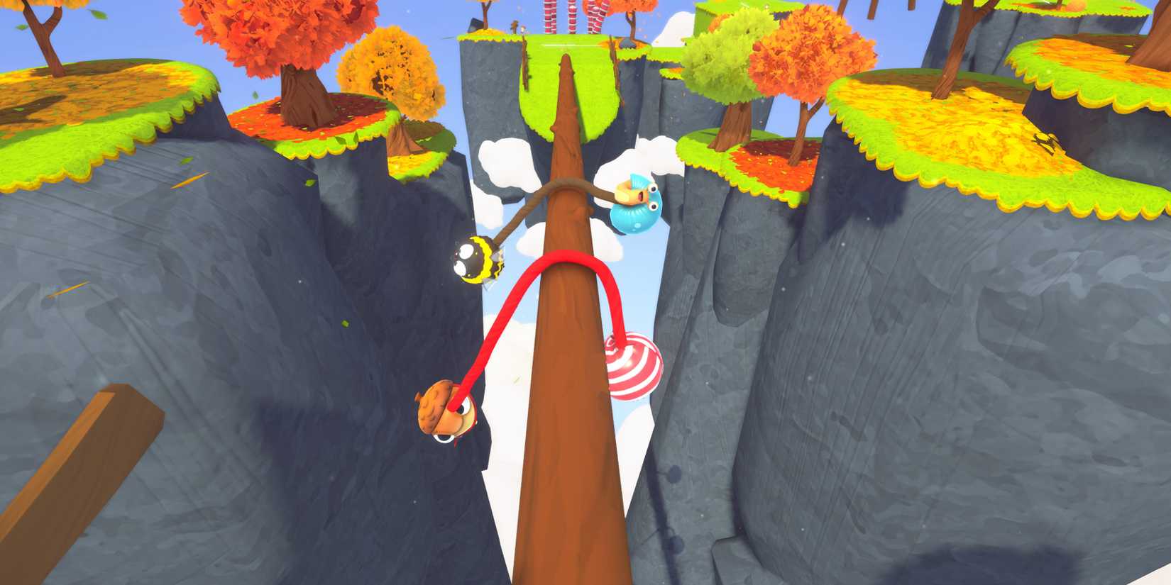 Two teams of two balancing on a log in an autumn Fling To The Finish course