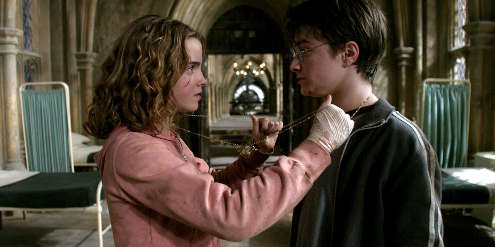 Hermion putting the chain for the time-turner around herself and Harry in Harry Potter and the Prisoner of Azkaban