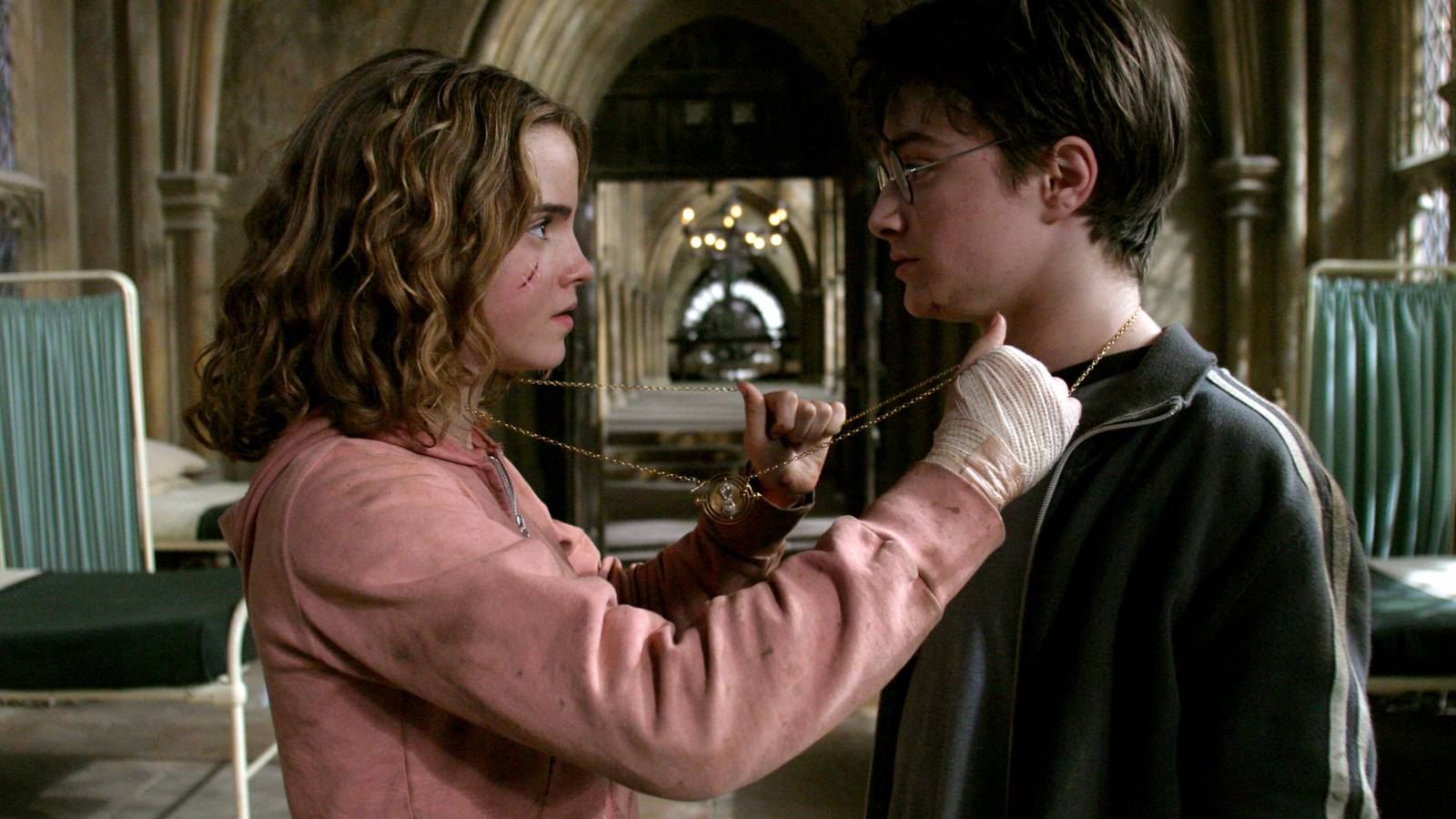 Hermion putting the chain for the time-turner around herself and Harry in Harry Potter and the Prisoner of Azkaban