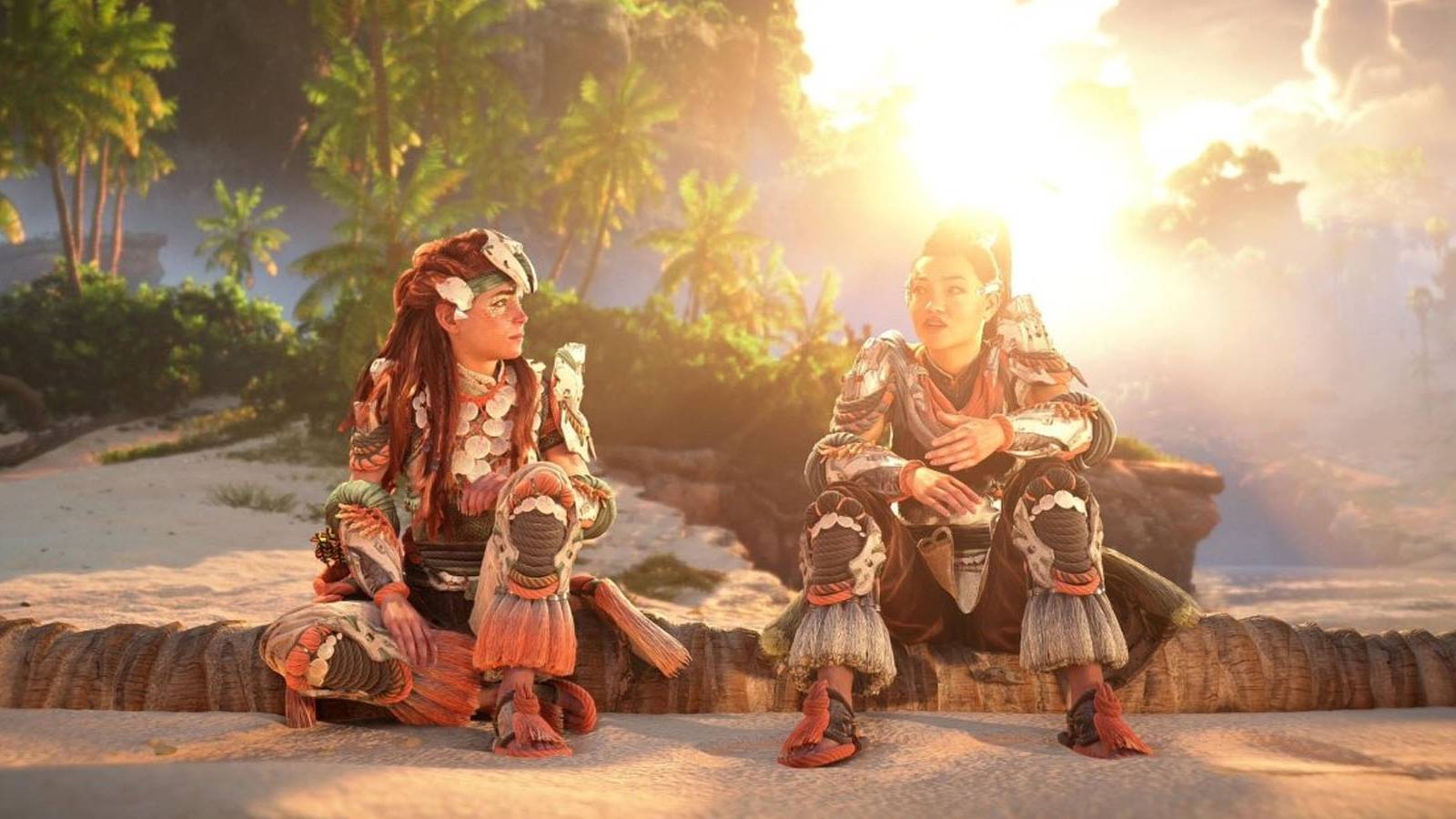 A screenshot of Aloy and Seyka sitting together and talking by the coast in Horizon Forbidden West: Burning Shores.