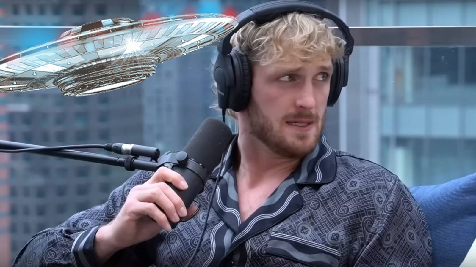 A screenshot of Logan Paul sitting and recording himself while a UFO hovers above him.