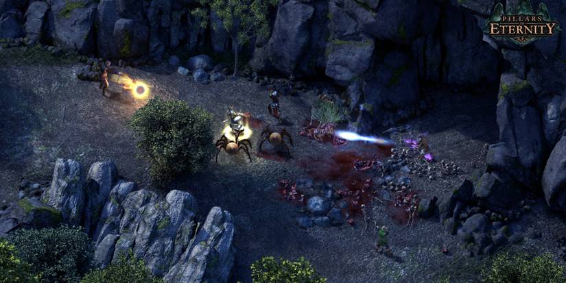 Players battling spider monsters at night