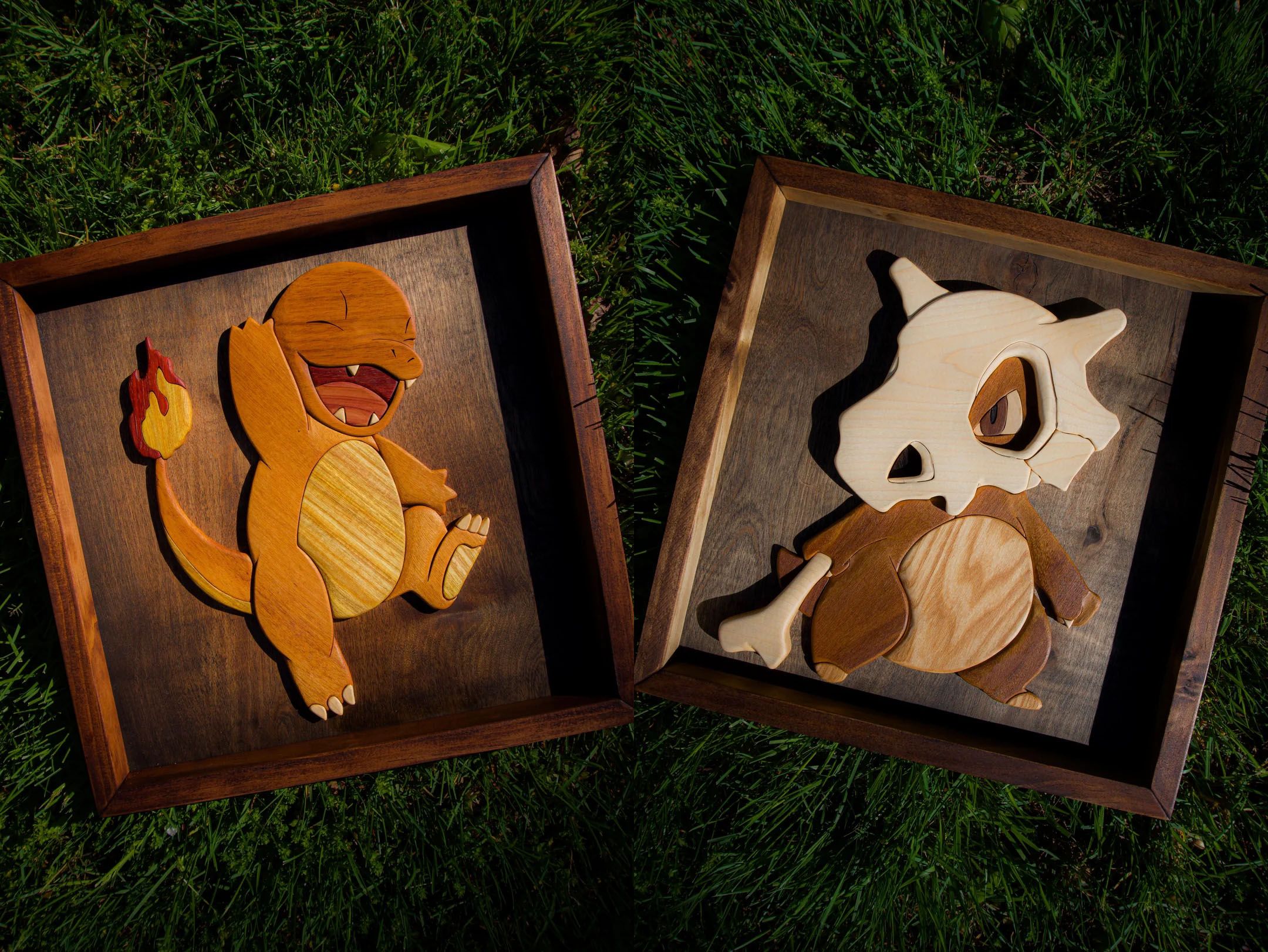 A pair of hardwood portraits featuring Charmander and Cubone from Pokemon.