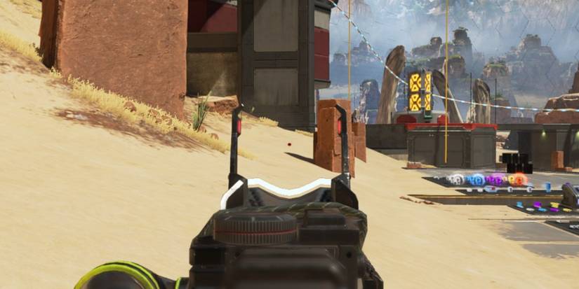 Red dot sight aiming at sand