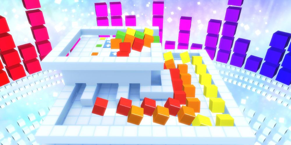 Red, orange, yellow, and green blocks marching in single file on a white platform. Image source: Steam