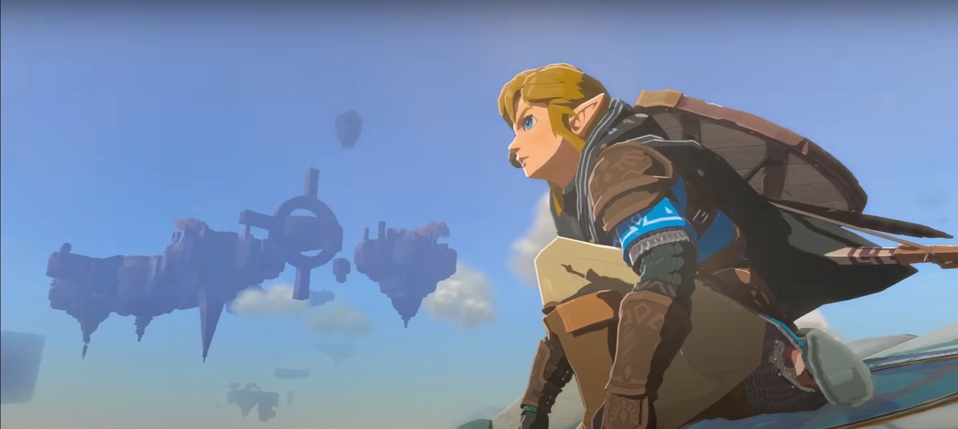 Link stands on a device and flies over Hyrule in The Legend of Zelda: Tears of the Kingdom.