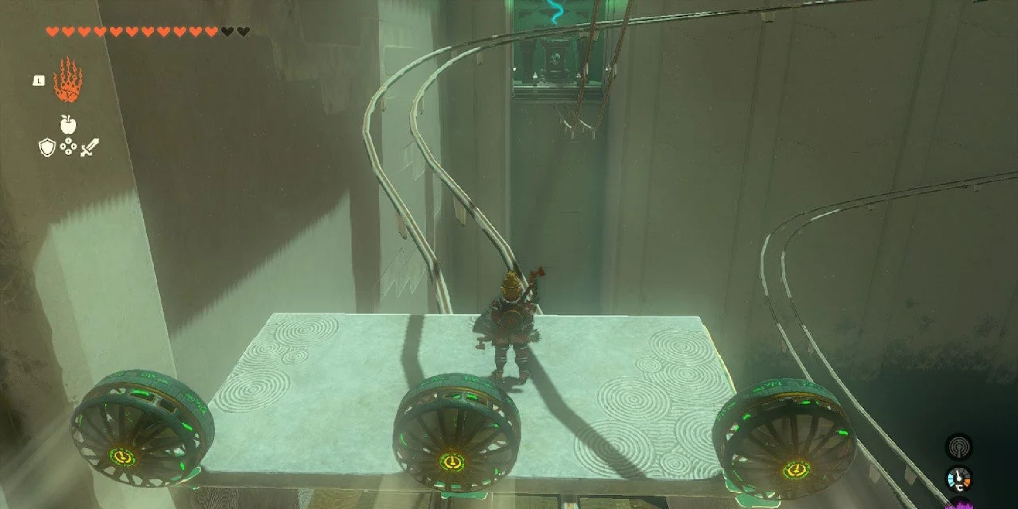 Link standing on a platform on rails, three fans propelling him forward.