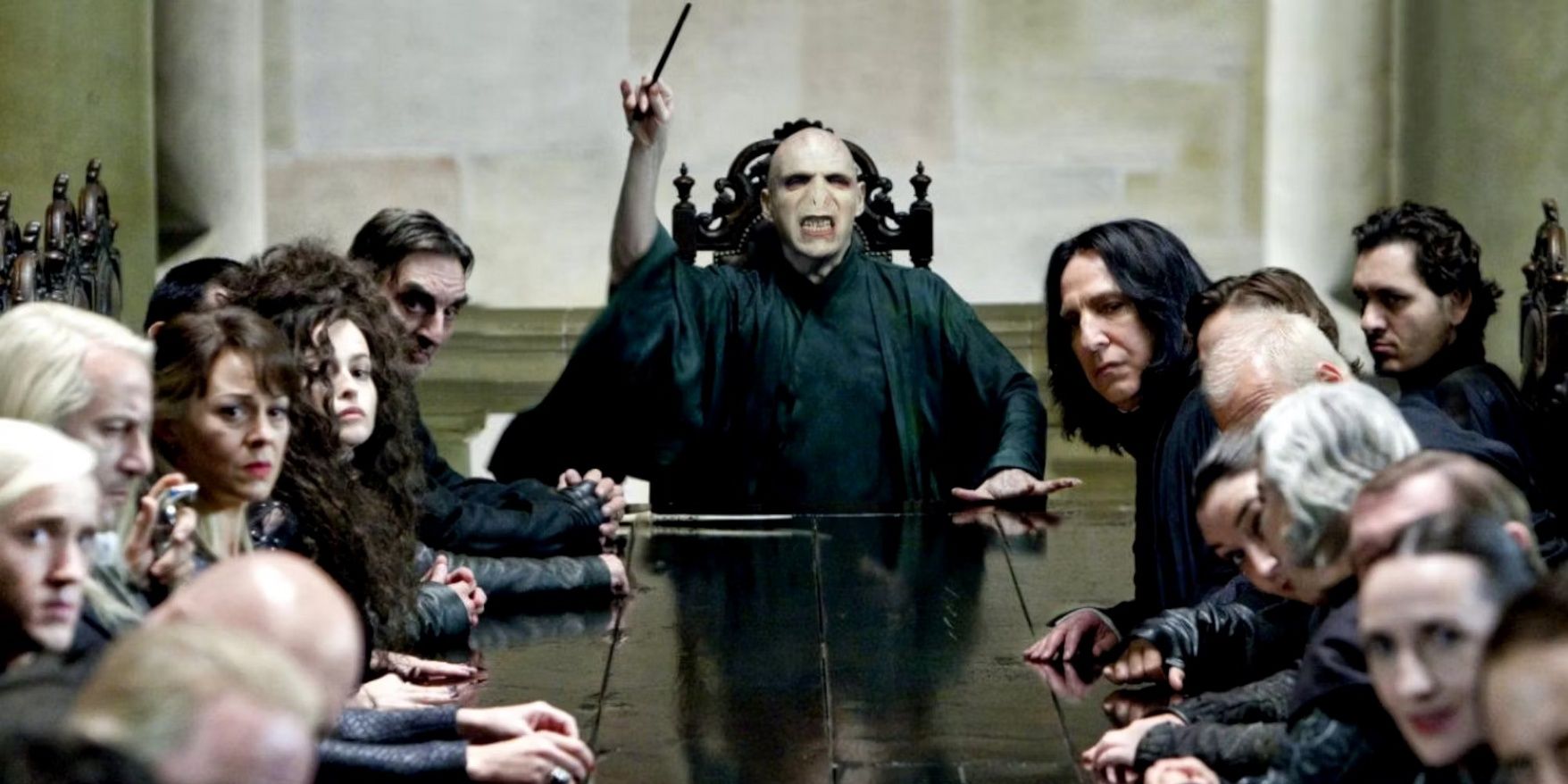 Voldemort at a table with Death Eaters in Harry Potter