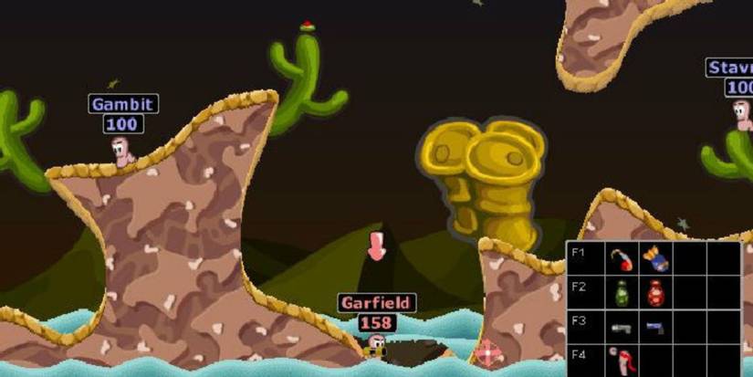 A battle in Worms 2 showing a worm called Garfield almost in the water