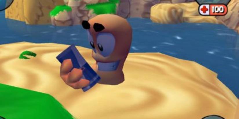 A worm holding a can and smiling in Worms 3D