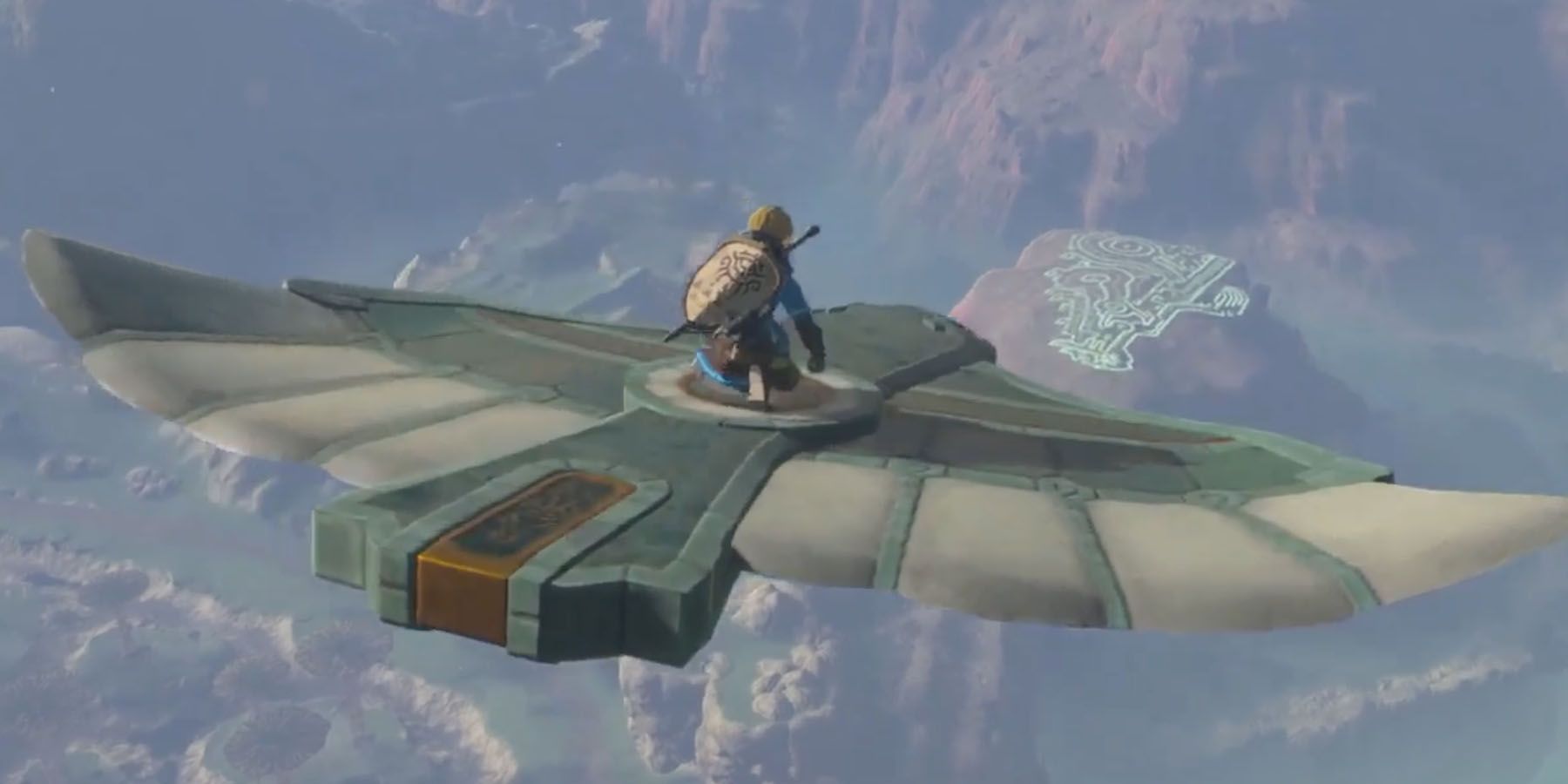 A screenshot of Link flying atop a birdlike stone structure in The Legend of Zelda: Tears of the Kingdom.
