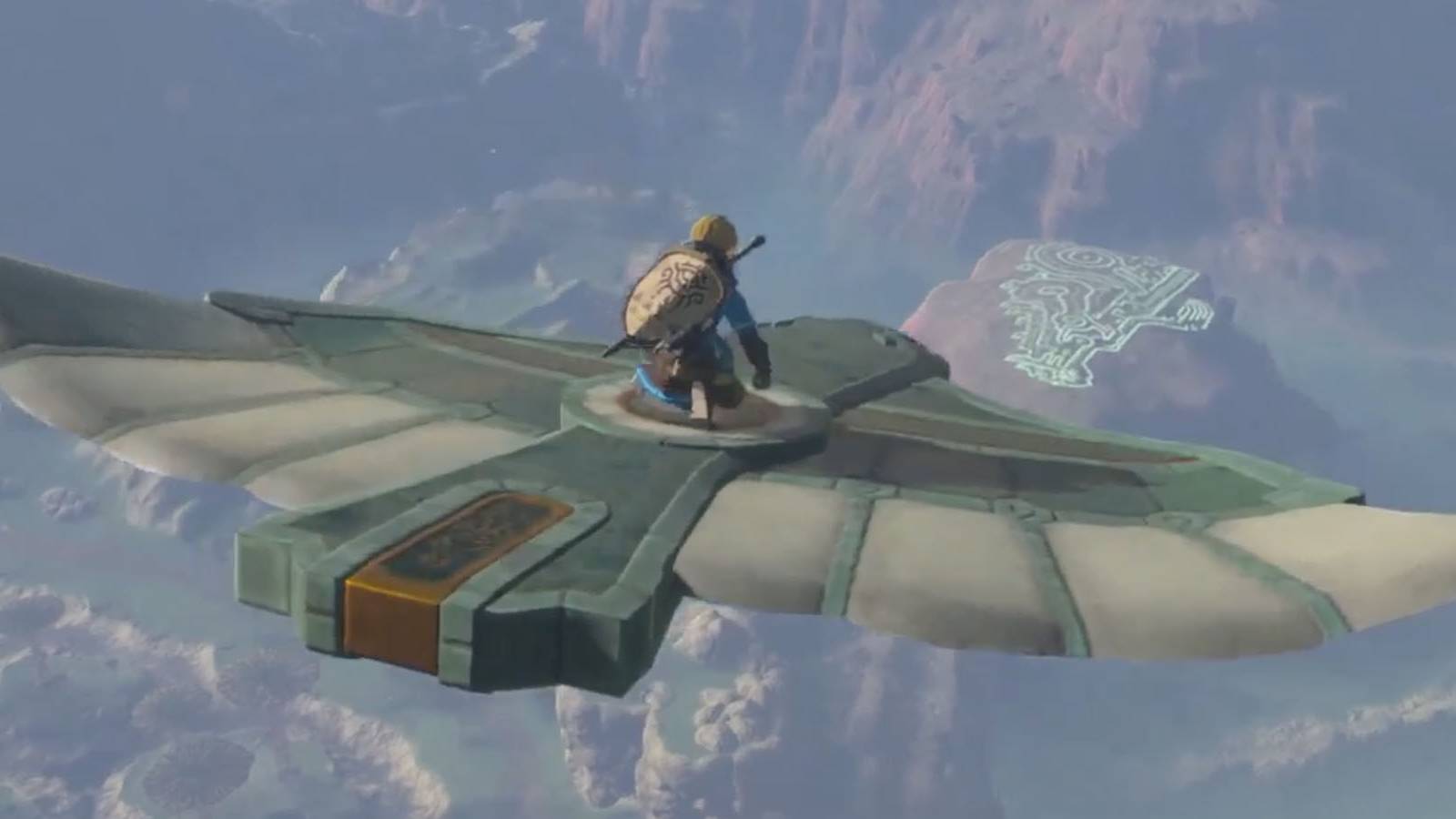 A screenshot of Link flying atop a birdlike stone structure in The Legend of Zelda: Tears of the Kingdom.