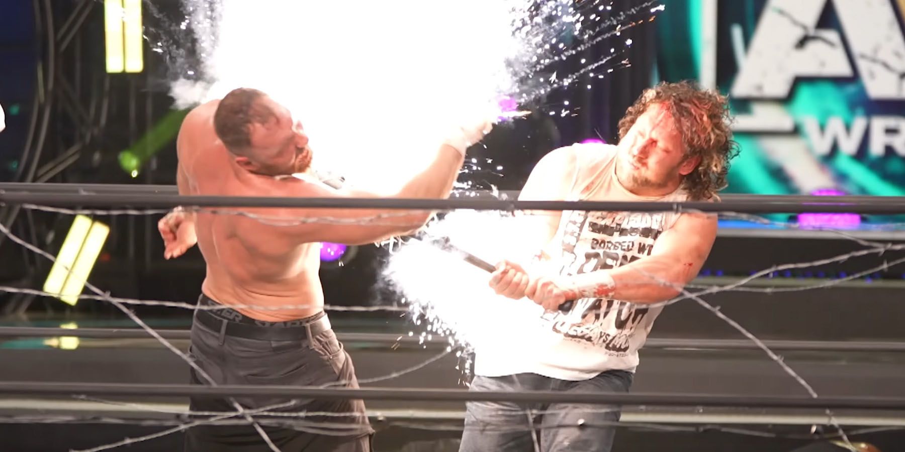A screenshot of Kenny Omega hitting Jon Moxley with an exploding barbwire bat during a match in AEW.