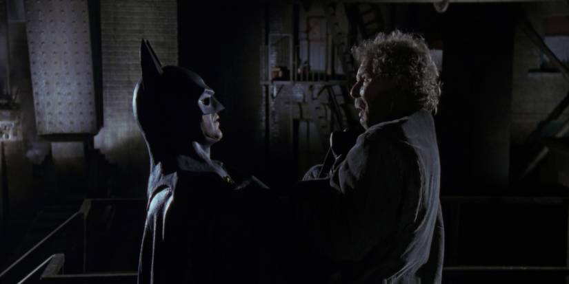 batman holding up a criminal