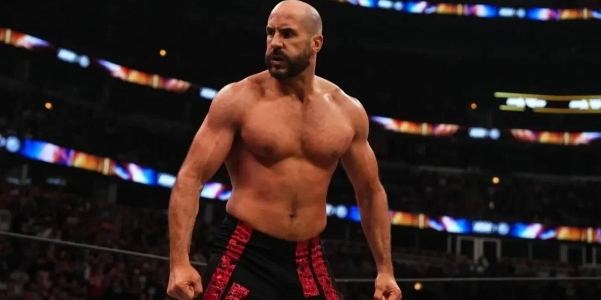 Former WWE and current AEW star Claudio Castagnoli in the ring with a stern look on his face, looking at someone who is not in the shot.