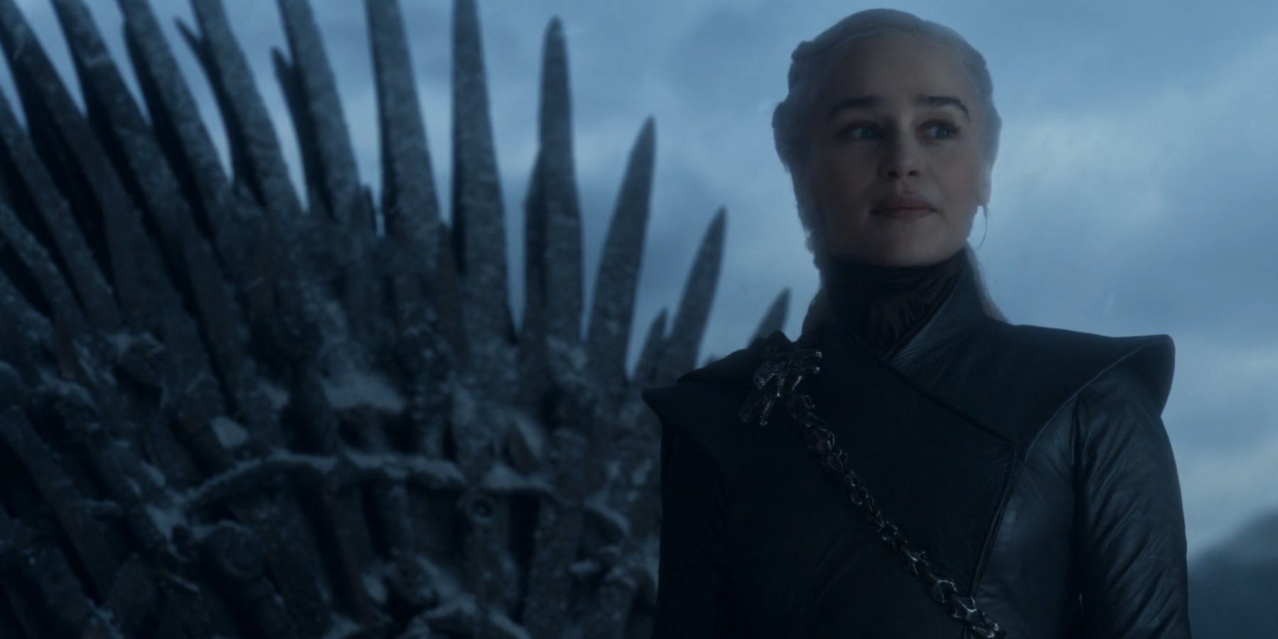 Daenerys Targaryen stands near the Iron Throne in Game of Thrones. 