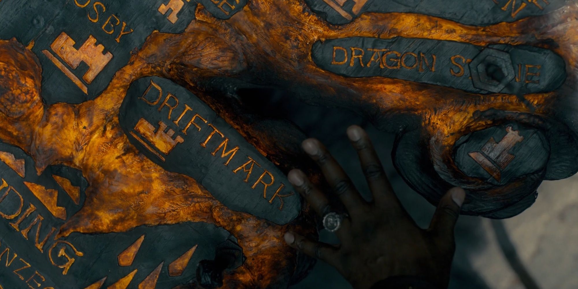 Lord Corlys Velaryon's hand touches the Painted Table in House of the Dragon.