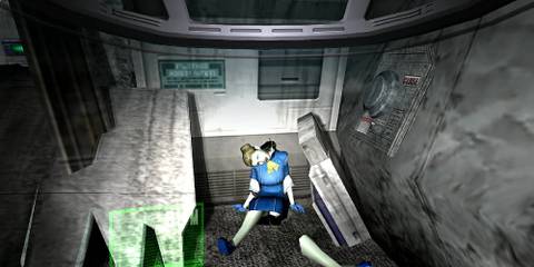 A dismembered body lies slumped against the wall in a room of metal.