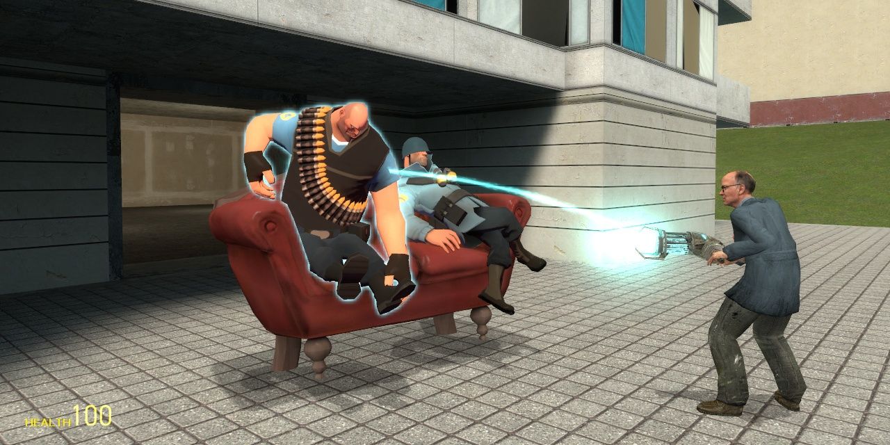 A scientist using a gravity gun on Team Fortress 2 characters sitting on a couch in Garry's Mod