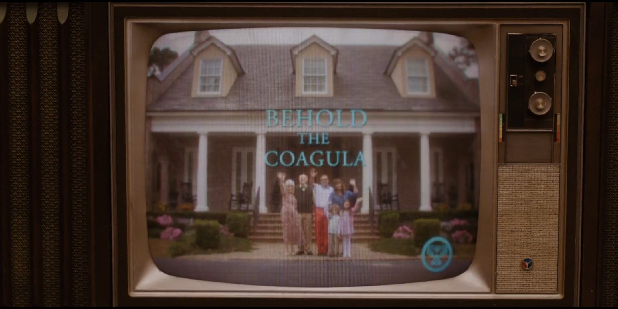 TV screen with the text 'Behold The Coagula' in Get Out