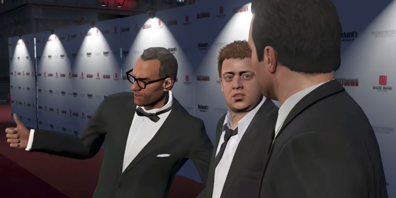 Devin, Jimmy, and Michael standing on the red carpet. Devin gives a thumbs up while Jimmy looks at Michael concerned
