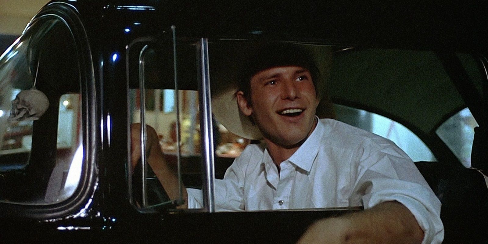 Harrison Ford driving a classic car in American Graffiti