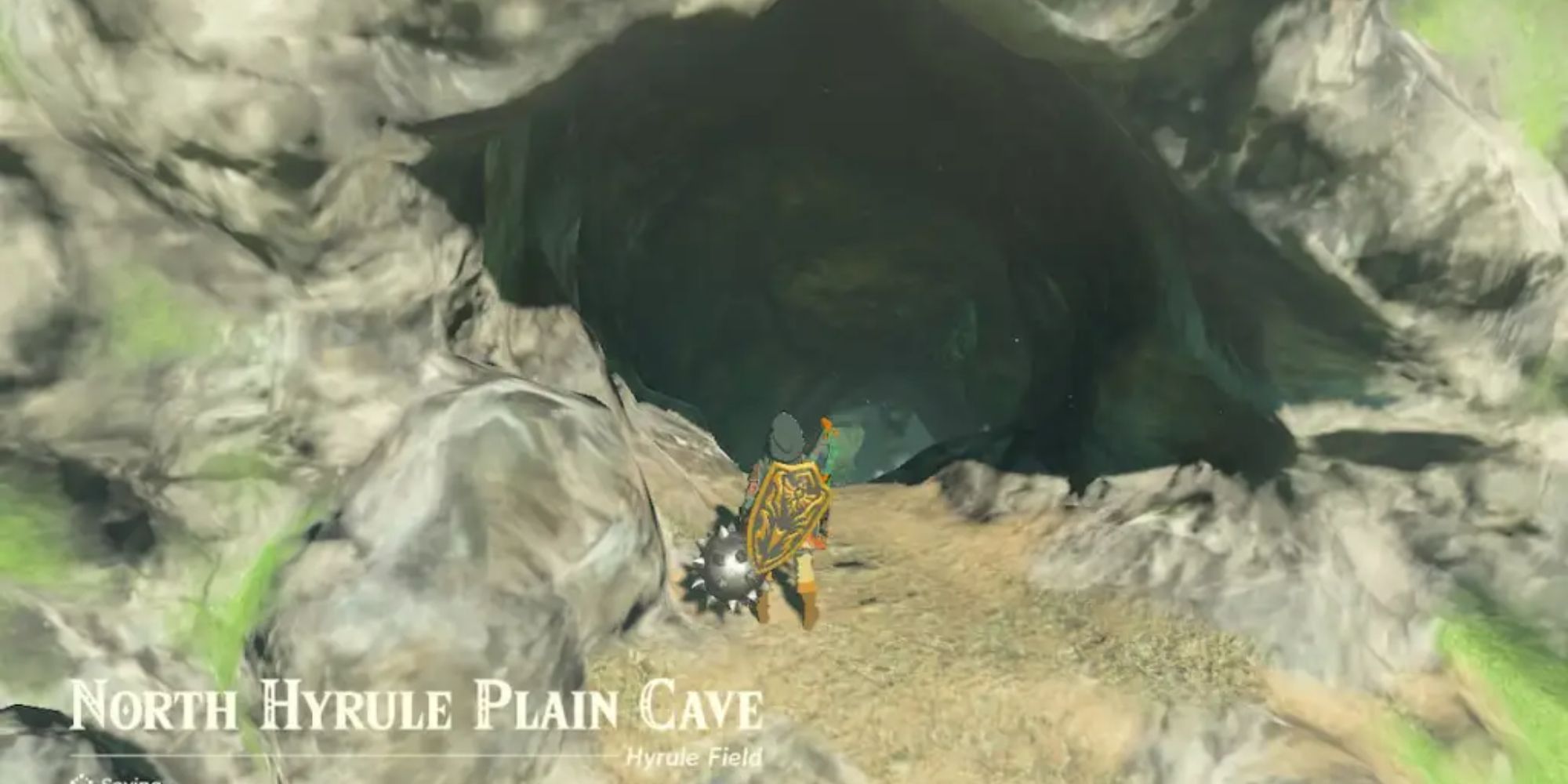 Link standing in front of a cave entrance