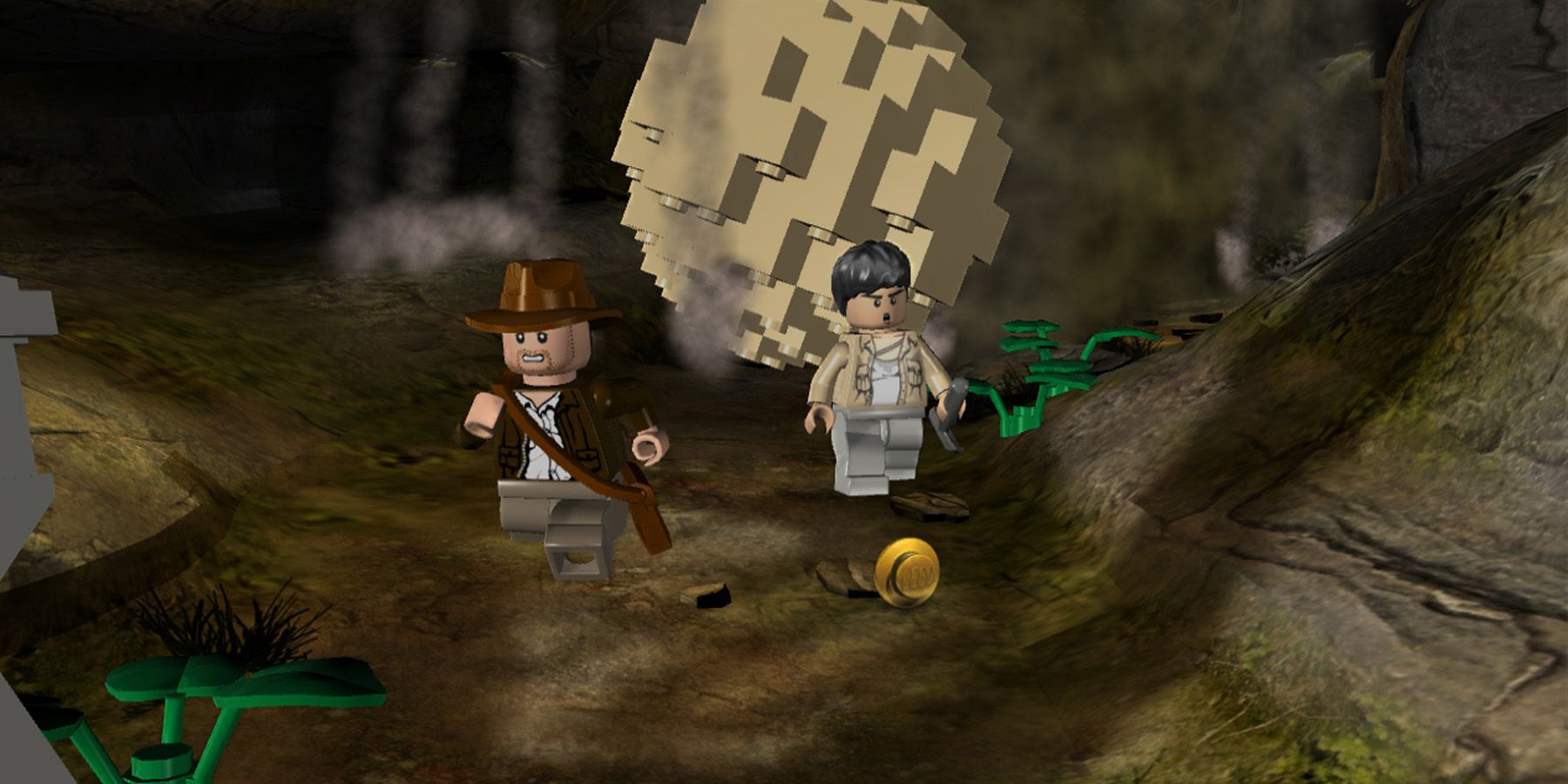 Indiana Jones and a partner escape a rolling boulder