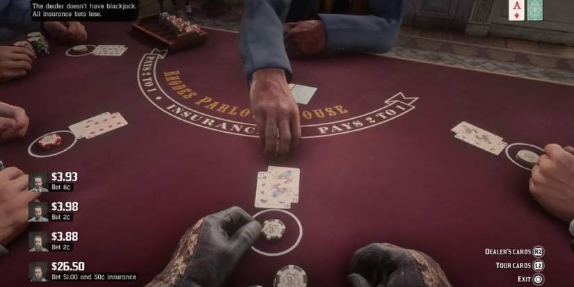 First person perspective of a red poker table, with several cards and hands visible. 