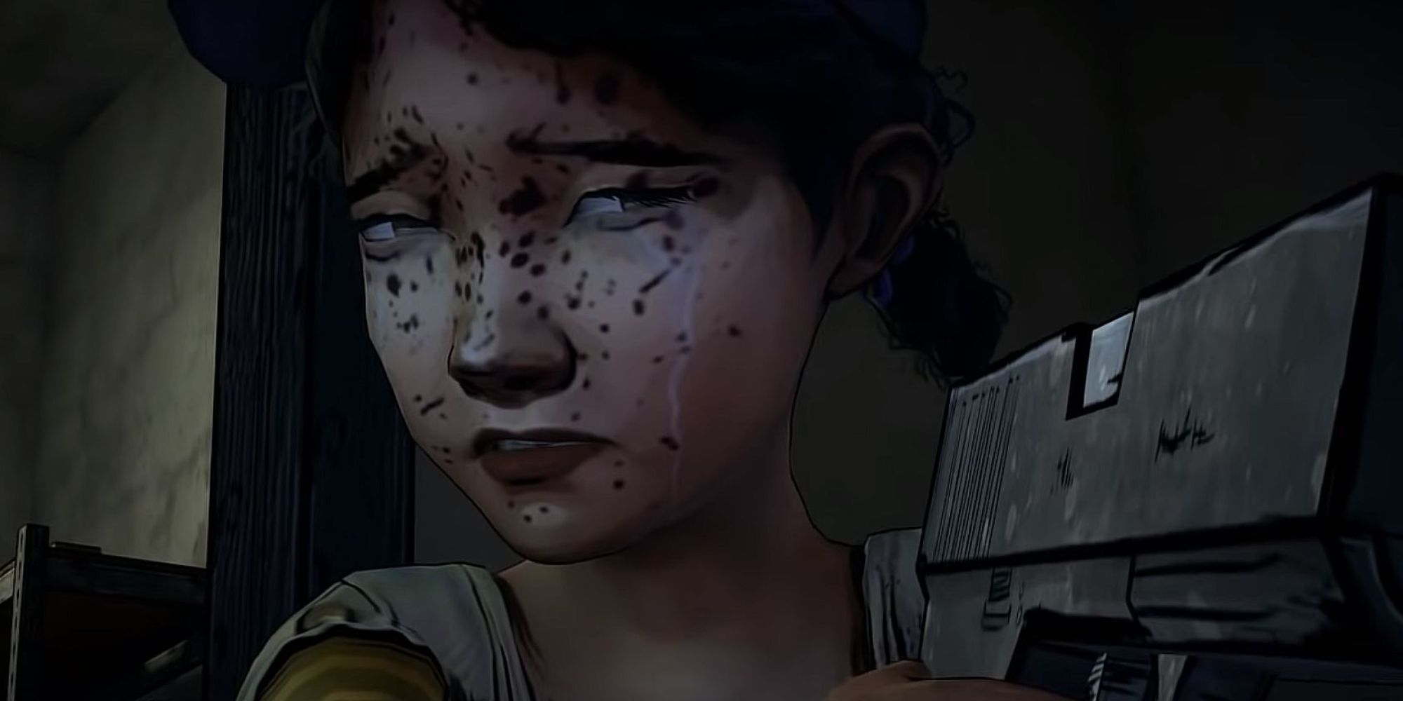 Telltale’s The Walking Dead Clementine holding gun at lee's face