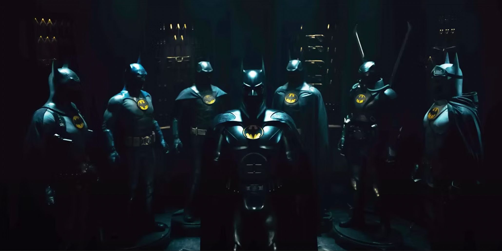 The seven Batman suits arranged on display in The Flash (2023)