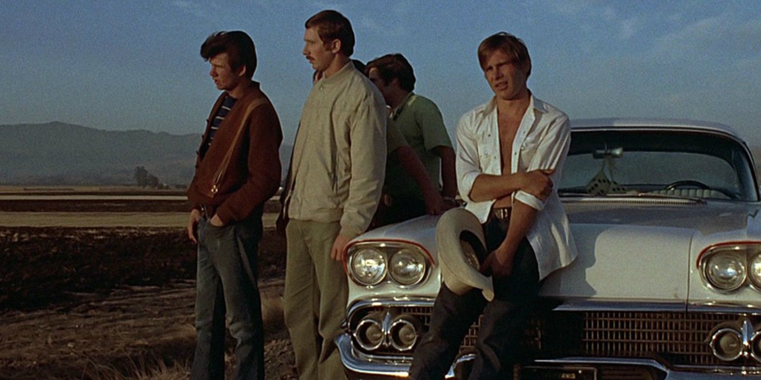 The guys hanging out at the crack of dawn in American Graffiti