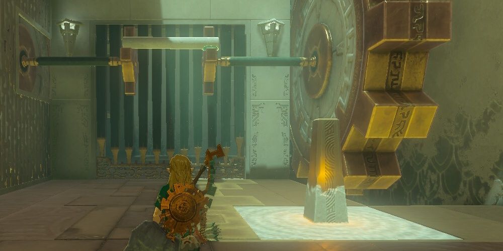 Link Standing Next To A Giant Cog Inside Riogok Shrine