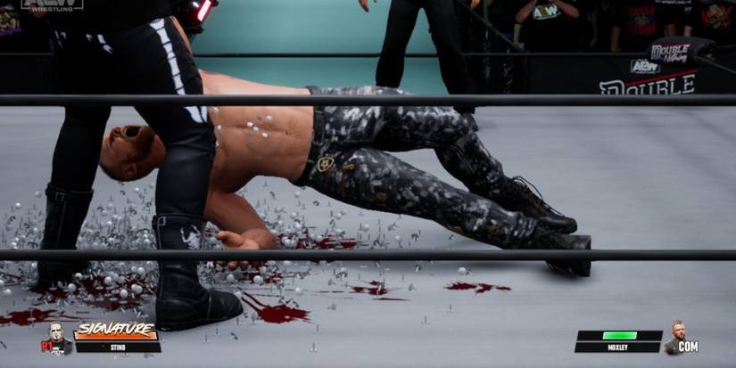 Sting slamming Jon Moxley into thumbtacs