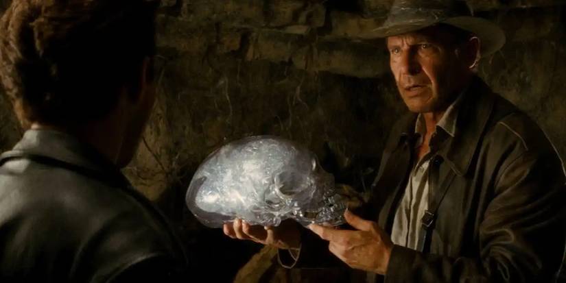 indiana jones holding the crystal skull of akator to mutt williams