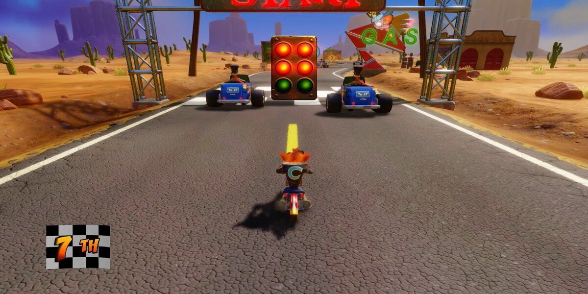 Crash Bandicoot on a motorbike at the beginning of a race with two vehicles in front