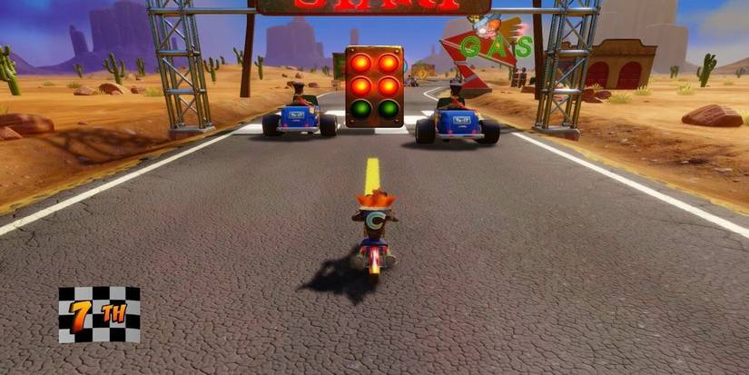 Crash Bandicoot on a motorbike at the beginning of a race with two vehicles in front