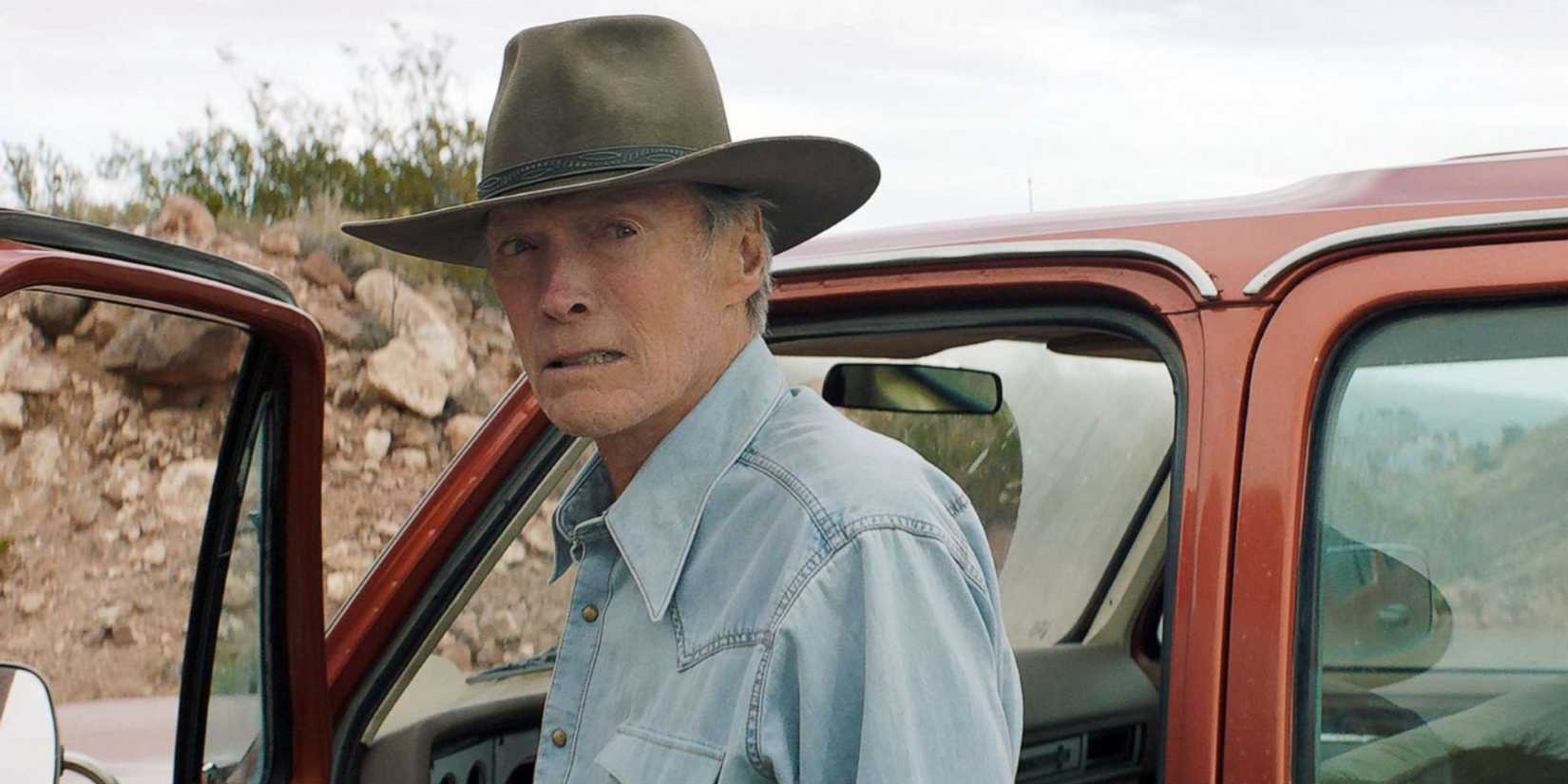 cry macho clint getting out of a car, wearing a hat