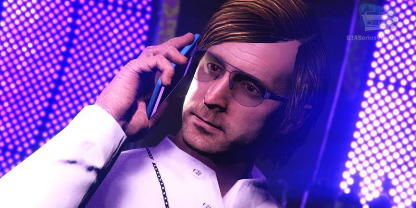 english dave on the phone, wearing a white suit.