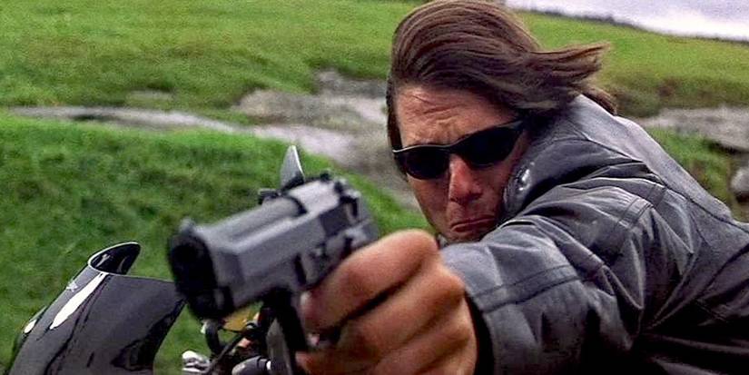 Ethan-Hunt-with-a-pistol-and-rides-a-motorcycle-in-Mission-Impossible-2