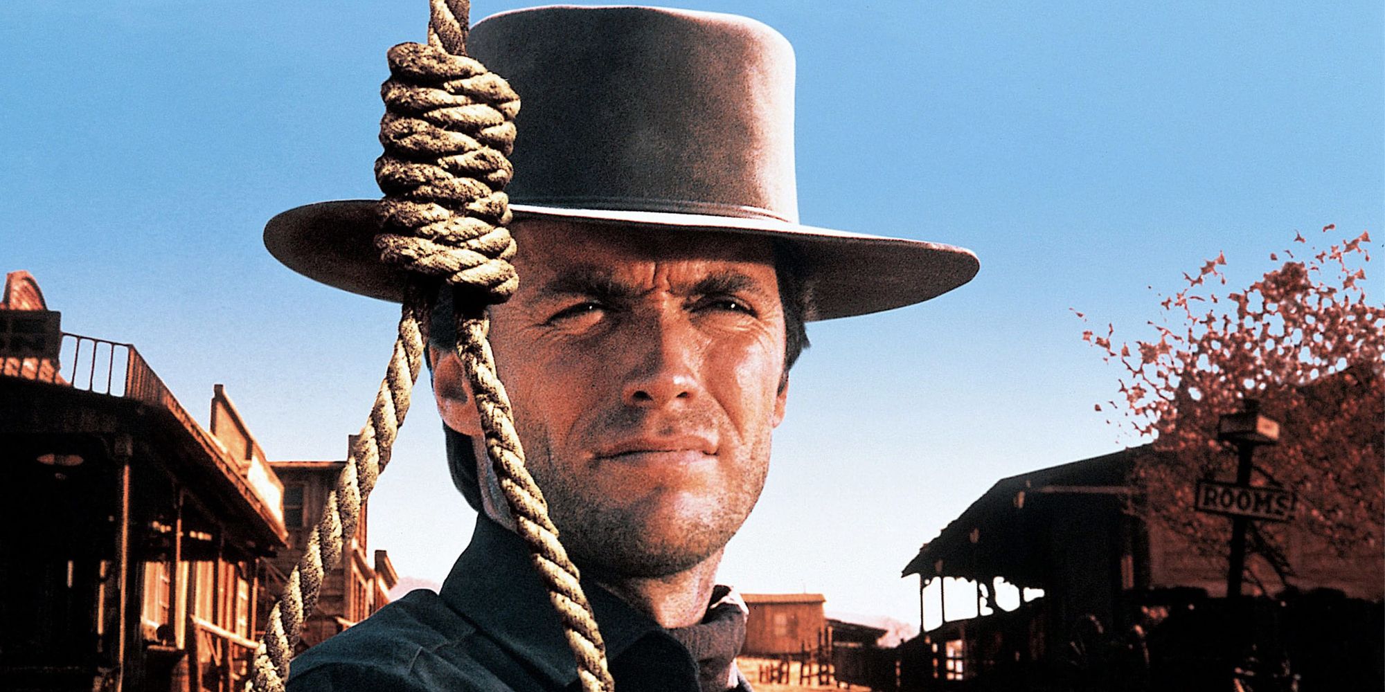 Jed Cooper wearing a cowboy hat, with a rope next to him