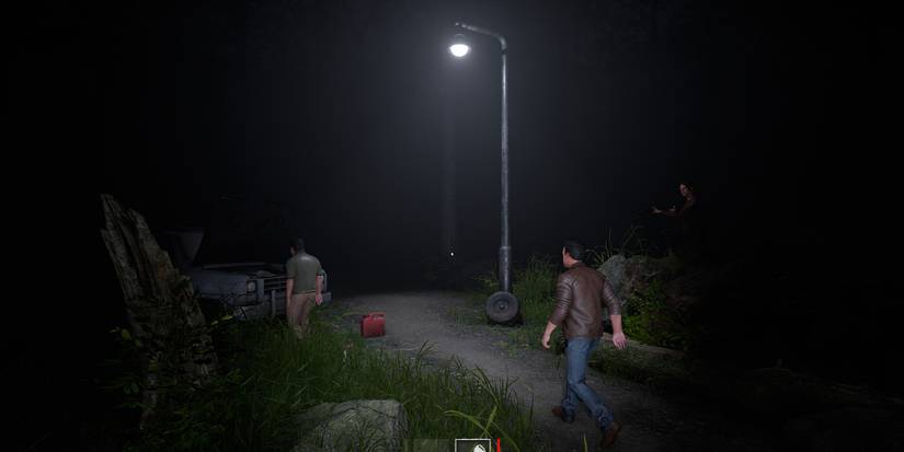 Three players stalk through a dark road, investigating an old broken down car.