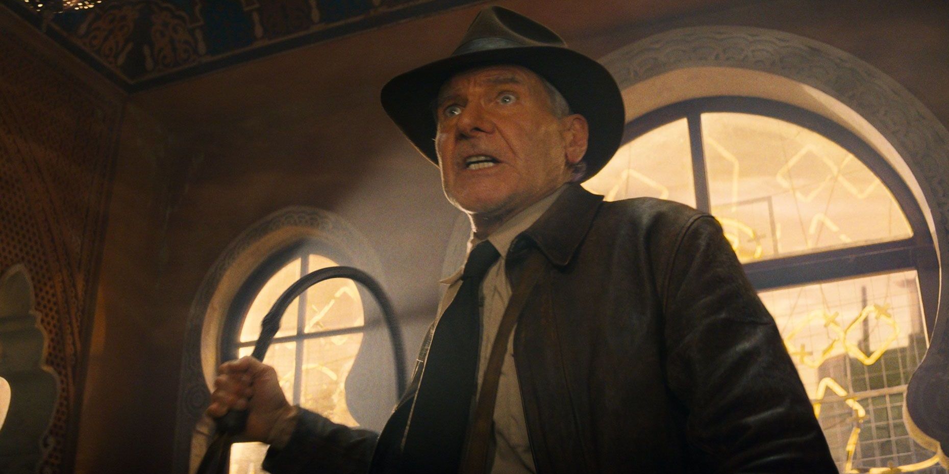 Indy with a whip in Indiana Jones and the Dial of Destiny
