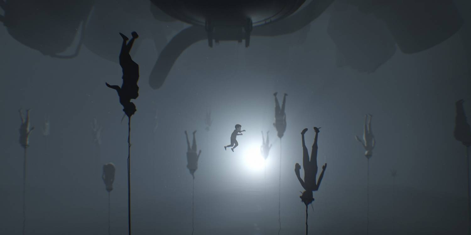 A boy swimming among bodies that are floating upside down by a rope in Inside