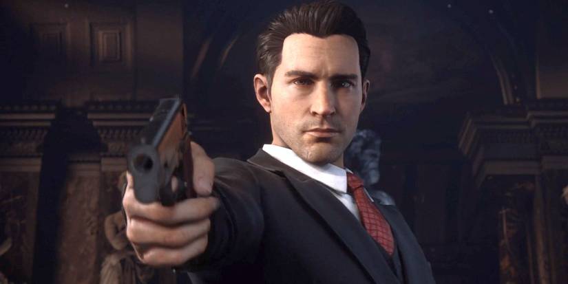 tommy in a suit, pointing a gun