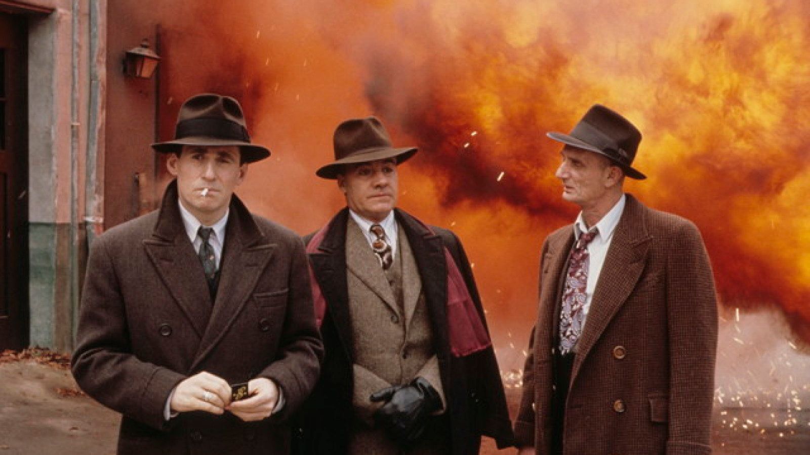 big explosion behind Reagan and associates, in hats and suits