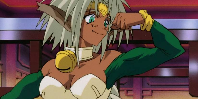Bust-up shot of Aisha ClanClan, flexing with a small grin on her face.
