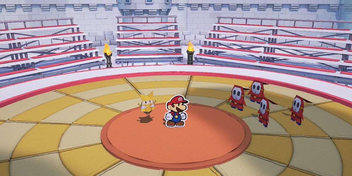 Four Shy Guys stand on rings facing Mario and Olivia in the middle of an empty castle arena in Paper Mario: The Origami King