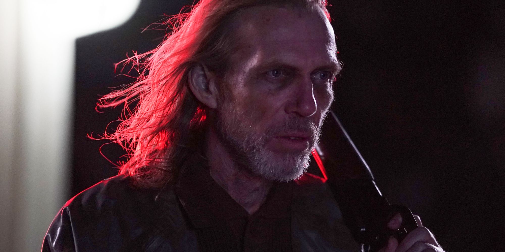Richard Brake in one of his movie roles, a shotgun resting on his shoulder as he walks through the night.
